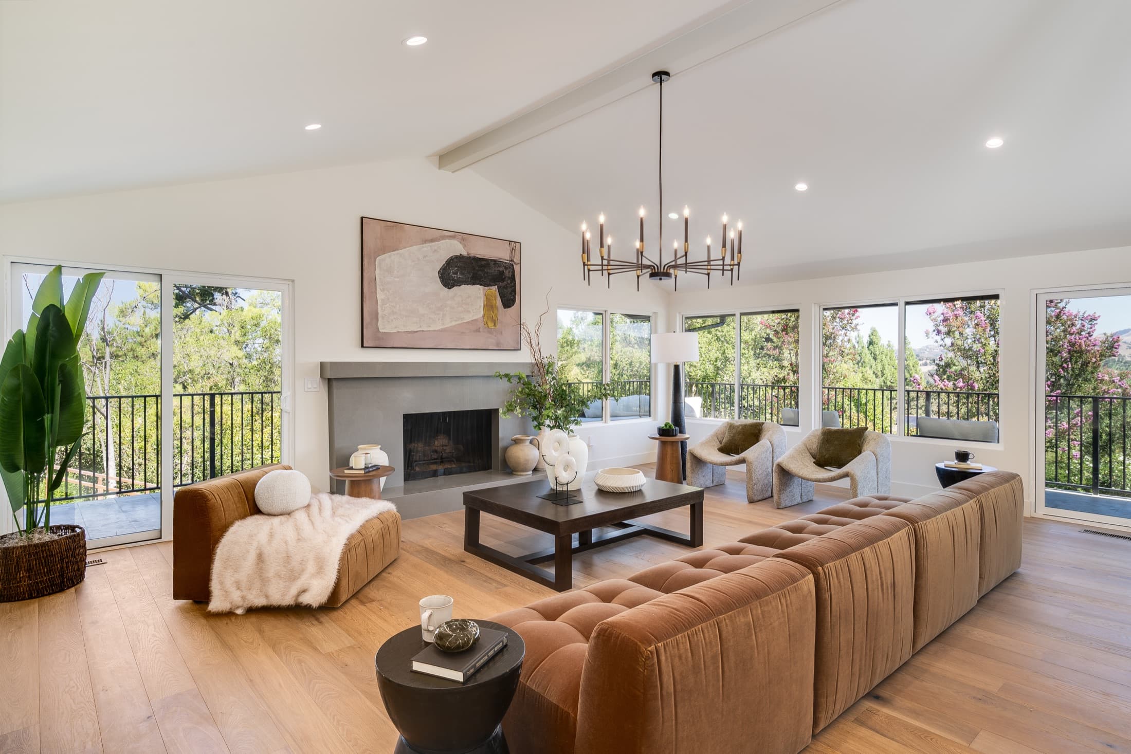481 Montcrest Place. The principal living room, with a full-height stone fireplace and a wall of glass to the deck.