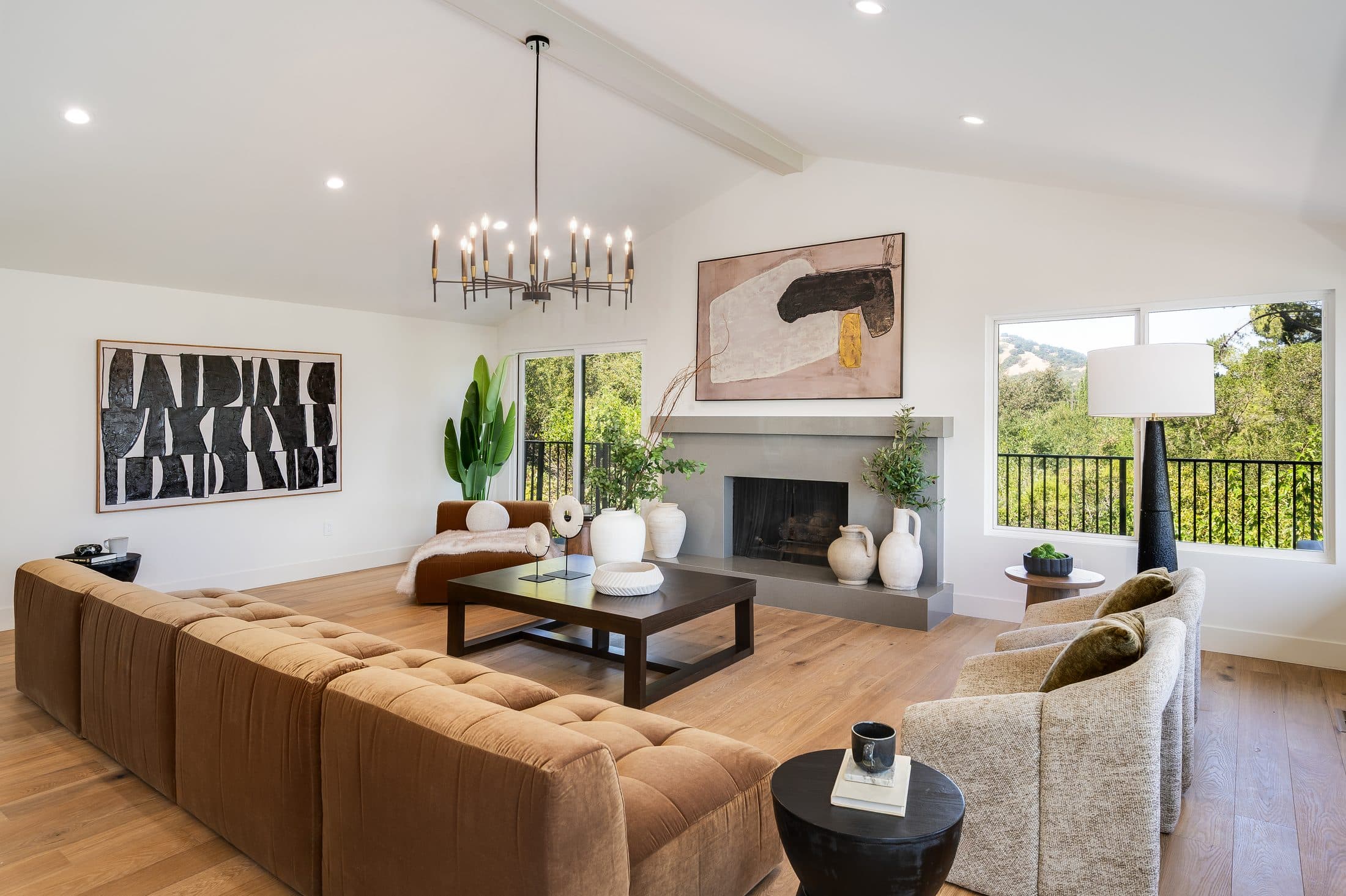 481 Montcrest Place. The principal living room, with leather seating at the stone fireplace.