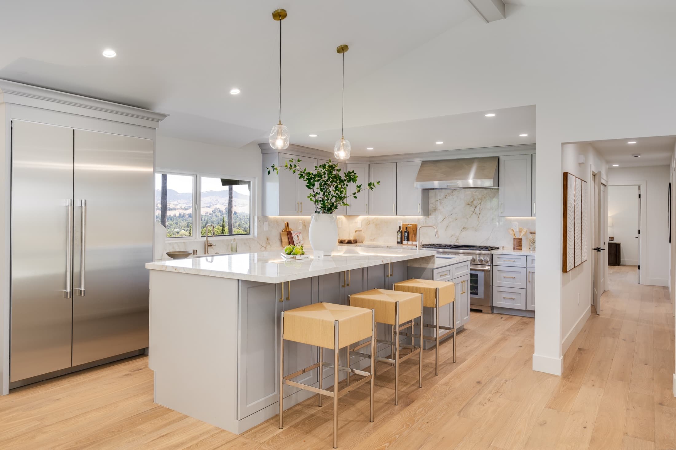 481 Montcrest Place. The kitchen: quartzite island, professional range, and cabinetry to the vault.