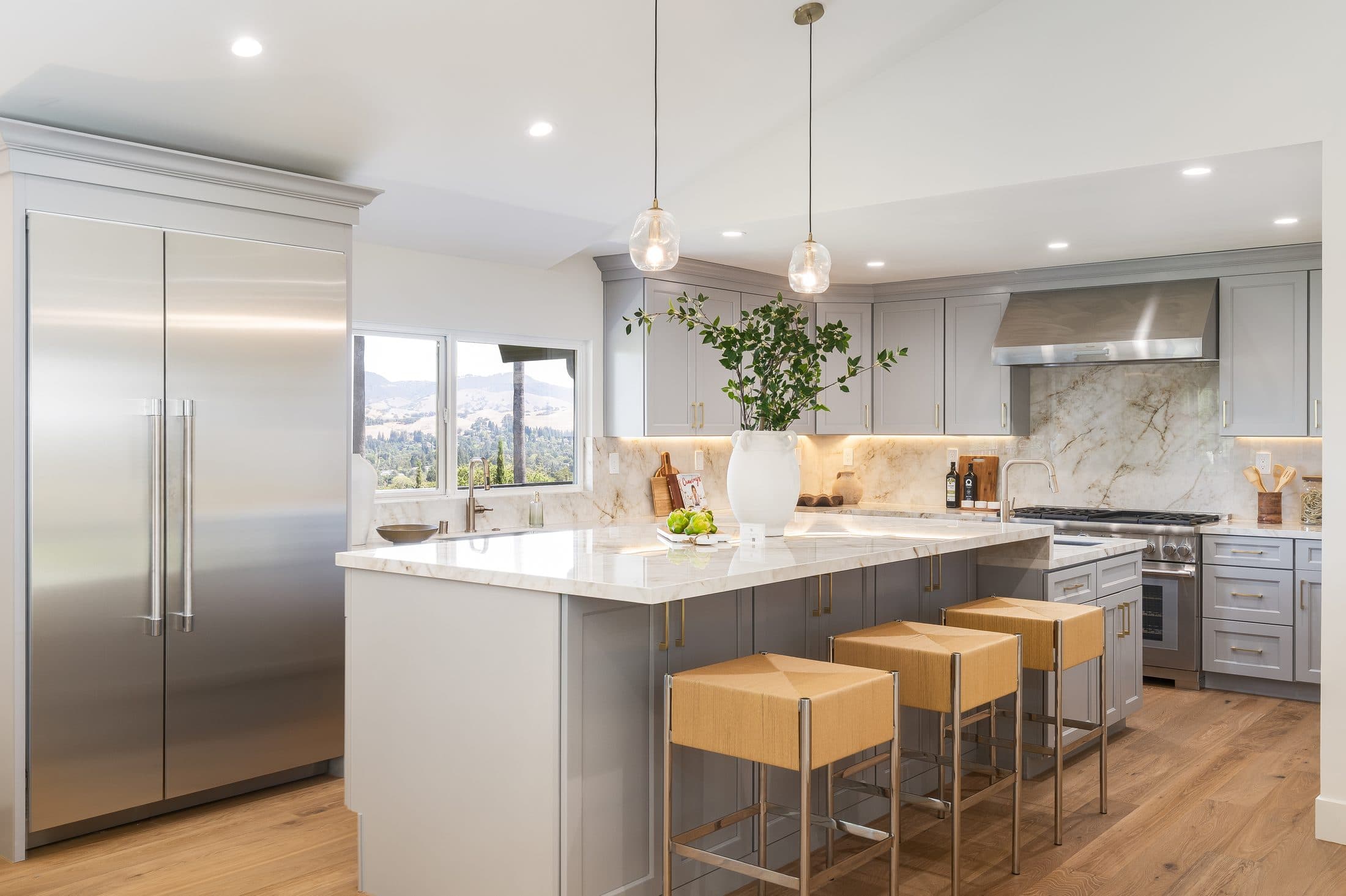 481 Montcrest Place. The kitchen from the dining side, stools along the island.